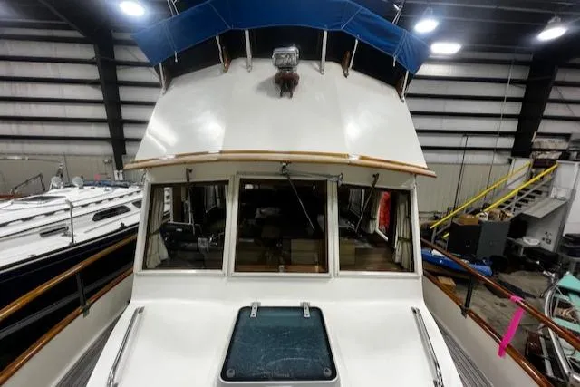 North Star Yacht Photos Pics 1984 Grand Banks Trawler in a storage facility, showcasing the front deck and cabin windows.