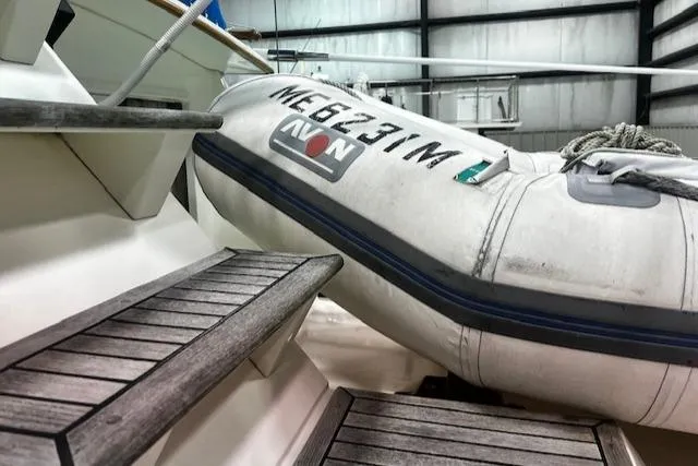 North Star Yacht Photos Pics 1984 Grand Banks Trawler with Avon dinghy on deck, wooden steps visible.