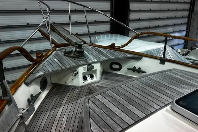 North Star Yacht Photos Pics 1984 Grand Banks Trawler deck with wooden railings and nautical equipment.