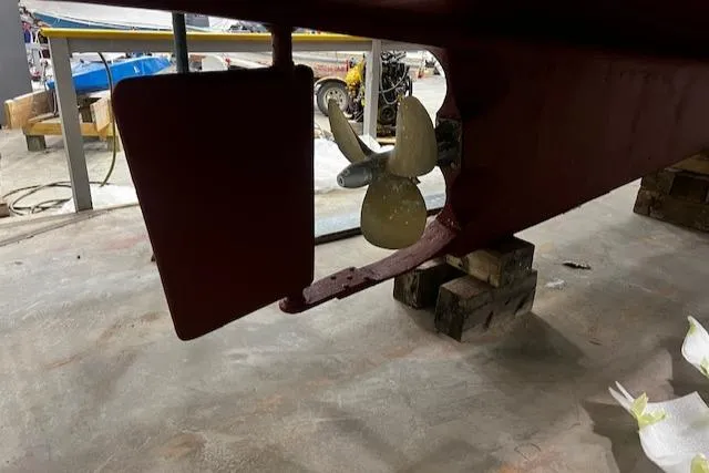 North Star Yacht Photos Pics 1984 Grand Banks Trawler propeller and rudder in a workshop setting.