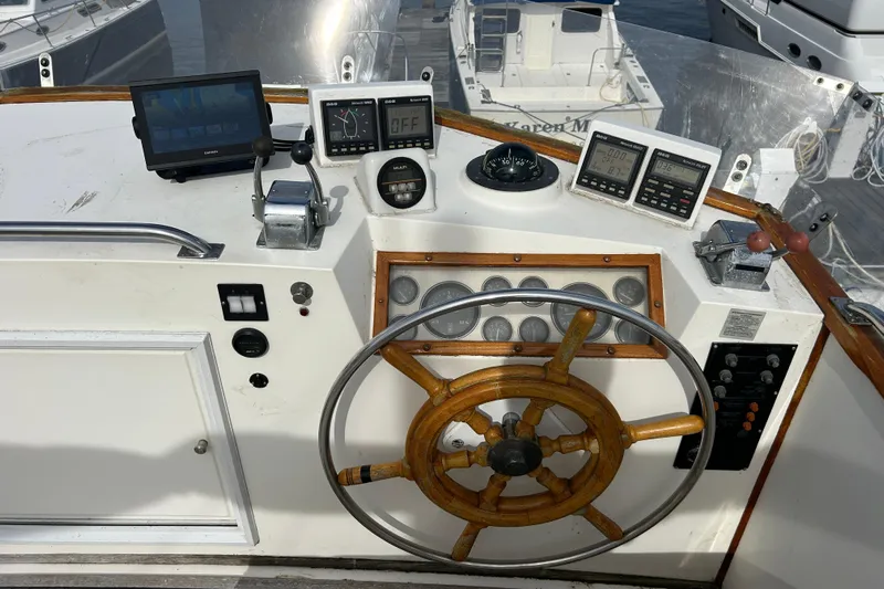  Yacht Photos Pics Helm of 1988 Grand Banks 42 Classic with wooden wheel and navigation instruments.