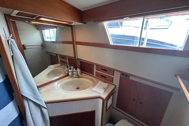  Yacht Photos Pics Bathroom interior of 1988 Grand Banks 42 Classic yacht with sink and mirror.