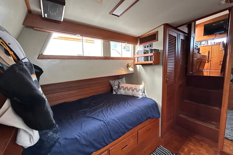  Yacht Photos Pics Cozy cabin interior of 1988 Grand Banks 42 Classic yacht with wooden furnishings and bed.