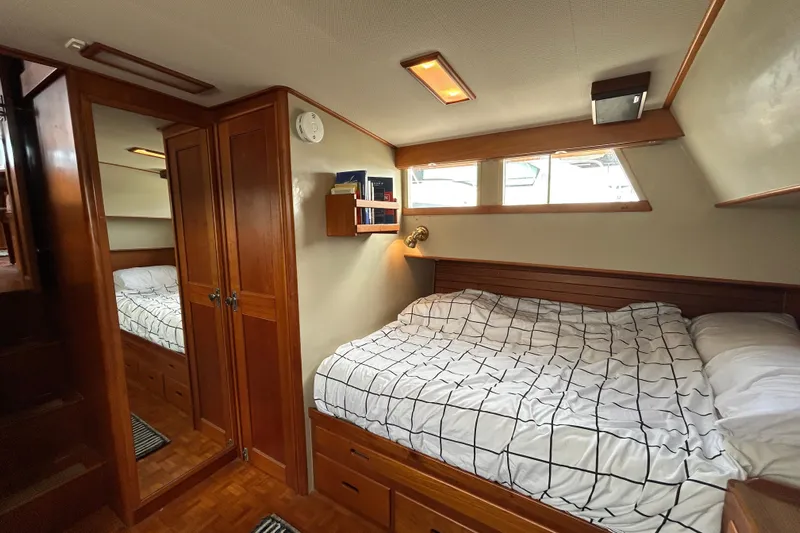 Yacht Photos Pics Cozy cabin interior of 1988 Grand Banks 42 Classic yacht with wood paneling and bed.