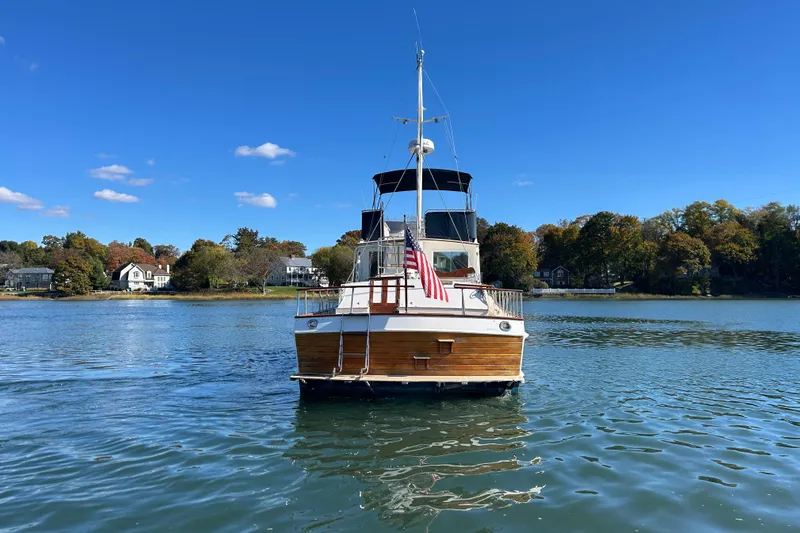  Yacht Photos Pics 1988 Grand Banks 42 Classic yacht on serene lake with clear blue sky.