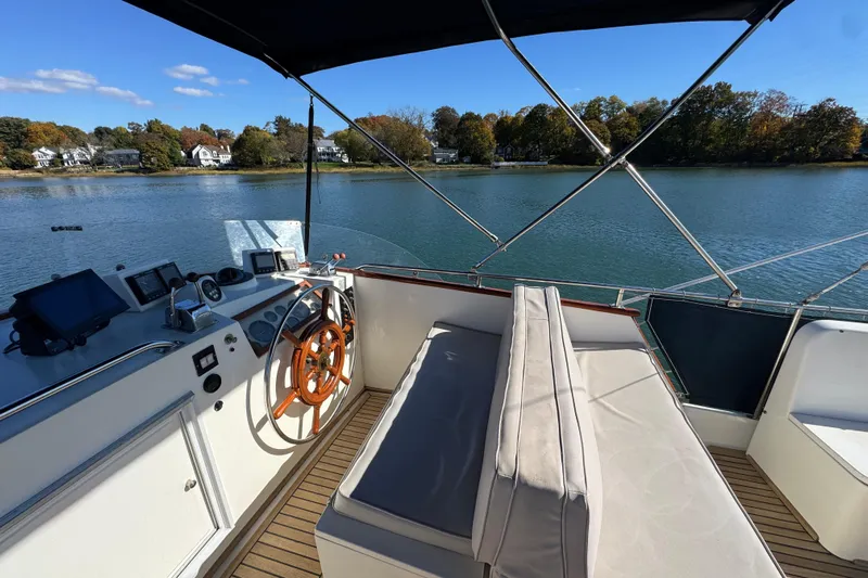  Yacht Photos Pics Helm of 1988 Grand Banks 42 Classic yacht with scenic waterfront view.