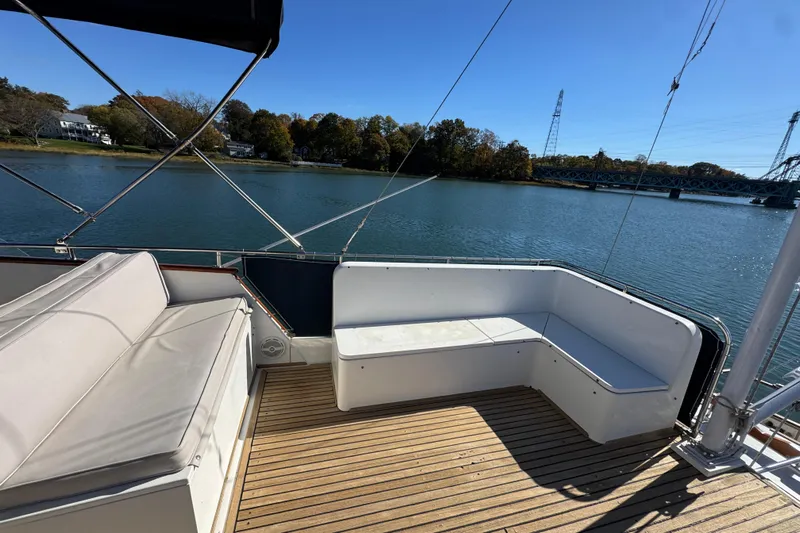  Yacht Photos Pics Deck seating area on a 1988 Grand Banks 42 Classic yacht, overlooking serene water and bridge.