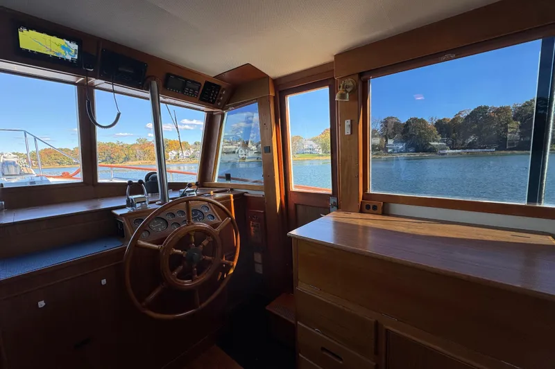  Yacht Photos Pics Interior of 1988 Grand Banks 42 Classic boat with wooden helm and scenic water view.
