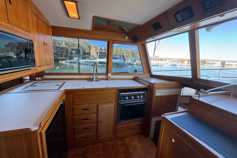 Yacht Photos Pics Interior of 1988 Grand Banks 42 Classic yacht with wooden cabinetry and marina view.