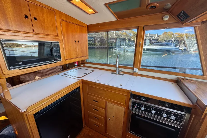  Yacht Photos Pics 1988 Grand Banks 42 Classic yacht kitchen with wood cabinetry and waterfront view.