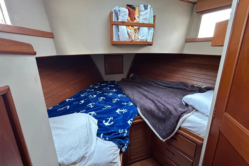  Yacht Photos Pics Cozy cabin interior of 1988 Grand Banks 42 Classic with twin beds and nautical decor.