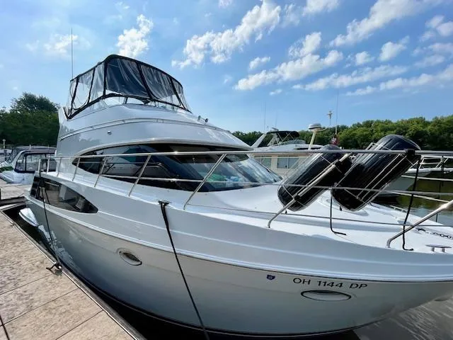"kimberly Cay" Yacht Photos Pics 2003 Carver 360 Sport Sedan docked under a clear blue sky.