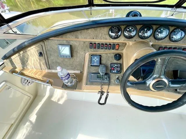 "kimberly Cay" Yacht Photos Pics 2003 Carver 360 Sport Sedan helm with steering wheel, gauges, and control panel.