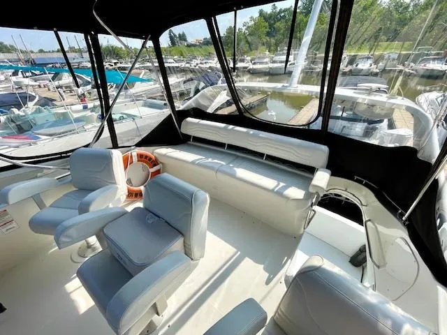 "kimberly Cay" Yacht Photos Pics 2003 Carver 360 Sport Sedan interior with marina view, featuring comfortable seating and life preserver.