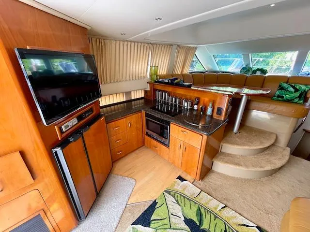 "kimberly Cay" Yacht Photos Pics Interior of 2003 Carver 360 Sport Sedan with kitchen, TV, and seating area.