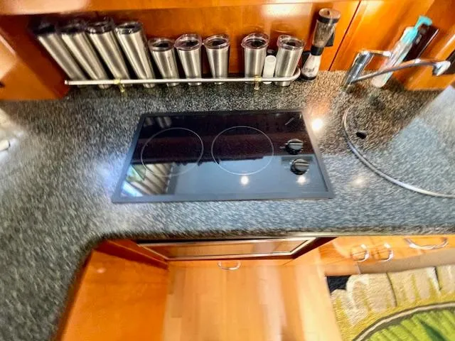 "kimberly Cay" Yacht Photos Pics 2003 Carver 360 Sport Sedan kitchen with stovetop, spice rack, and sink.