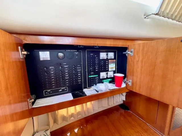 "kimberly Cay" Yacht Photos Pics Electrical panel inside 2003 Carver 360 Sport Sedan yacht with wooden cabinetry.