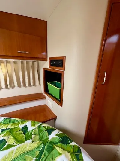 "kimberly Cay" Yacht Photos Pics Interior of 2003 Carver 360 Sport Sedan with wood cabinetry and tropical bedding.