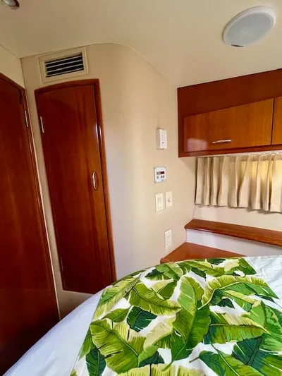 "kimberly Cay" Yacht Photos Pics Interior of 2003 Carver 360 Sport Sedan with wood paneling and tropical bedding.