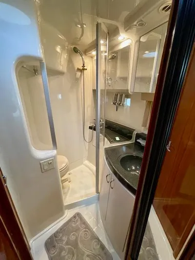 "kimberly Cay" Yacht Photos Pics 2003 Carver 360 Sport Sedan bathroom with shower, sink, and toilet in compact, modern design.