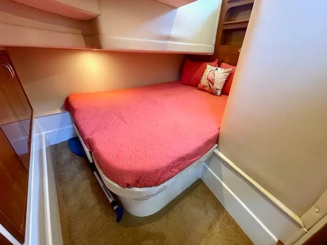 "kimberly Cay" Yacht Photos Pics 2003 Carver 360 Sport Sedan cabin with red bedding and cozy interior design.