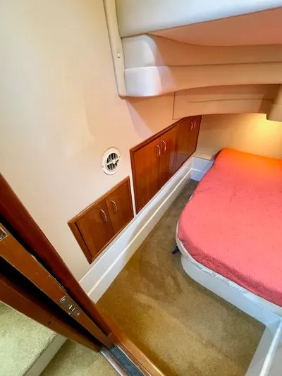 "kimberly Cay" Yacht Photos Pics Interior cabin of 2003 Carver 360 Sport Sedan with bed and wooden storage cabinets.