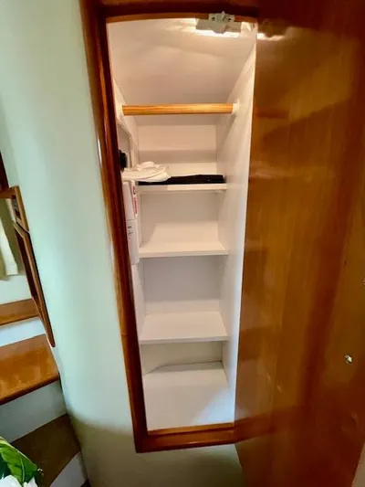 "kimberly Cay" Yacht Photos Pics Open wooden closet with shelves inside a 2003 Carver 360 Sport Sedan.