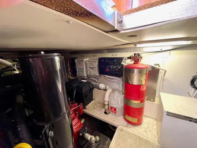 "kimberly Cay" Yacht Photos Pics Engine room of 2003 Carver 360 Sport Sedan with fire extinguisher and control panel.