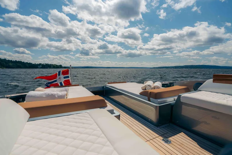  Yacht Photos Pics Luxurious 2022 Riva Dolceriva yacht deck with sunbeds and scenic ocean view.