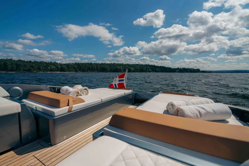  Yacht Photos Pics Luxurious 2022 Riva Dolceriva yacht deck with sun loungers and scenic water view.