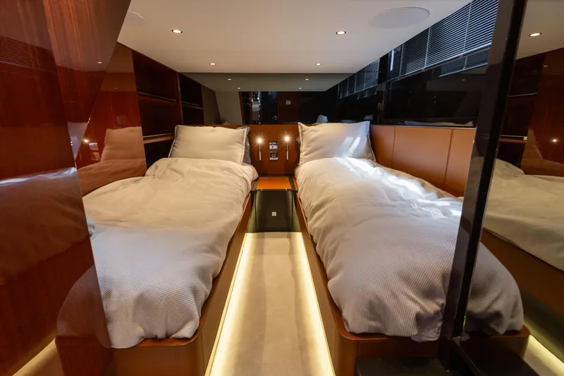  Yacht Photos Pics Luxurious 2022 Riva Dolceriva yacht cabin with twin beds and elegant wood paneling.