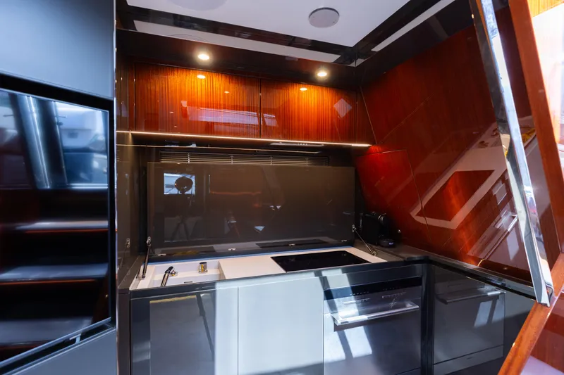  Yacht Photos Pics Modern kitchen interior on 2022 Riva Dolceriva yacht, featuring sleek cabinetry and ambient lighting.