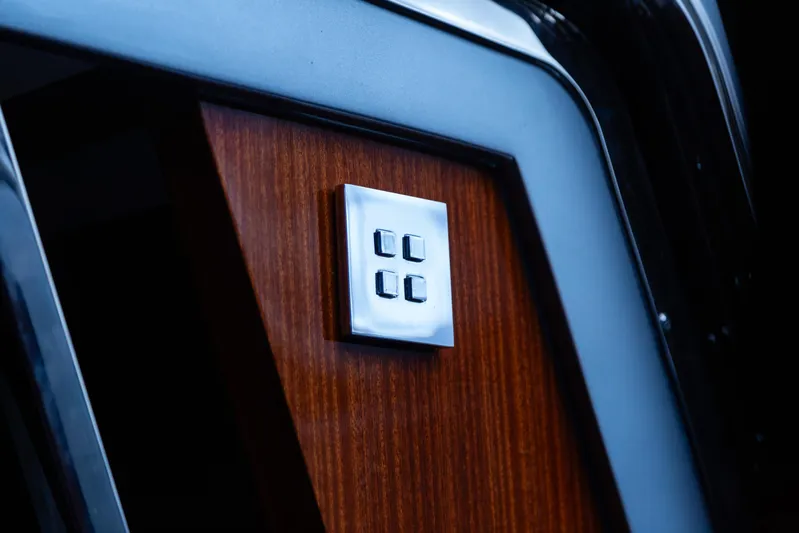  Yacht Photos Pics 2022 Riva Dolceriva yacht interior detail with sleek wood panel and modern control buttons.