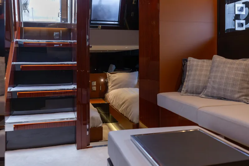  Yacht Photos Pics Luxurious interior of 2022 Riva Dolceriva yacht with elegant seating and cozy bedroom.