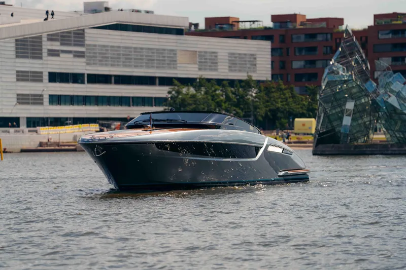  Yacht Photos Pics 2022 Riva Dolceriva luxury yacht cruising in urban waterfront setting.