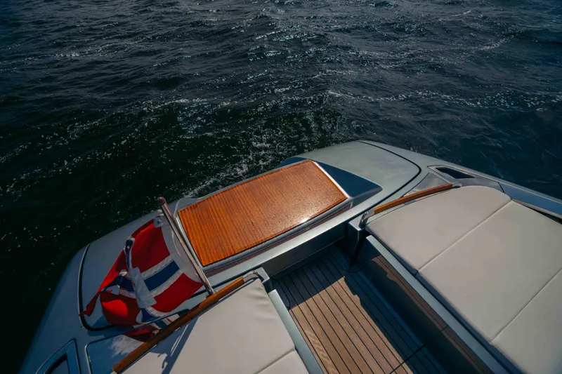  Yacht Photos Pics 2022 Riva Dolceriva yacht deck with flag, cruising on open water.