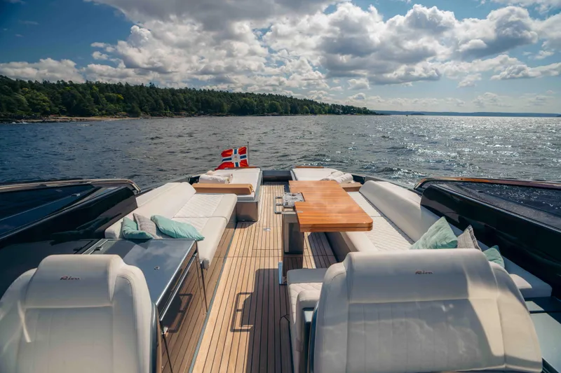  Yacht Photos Pics Luxurious 2022 Riva Dolceriva yacht with elegant seating, cruising on a scenic lake.