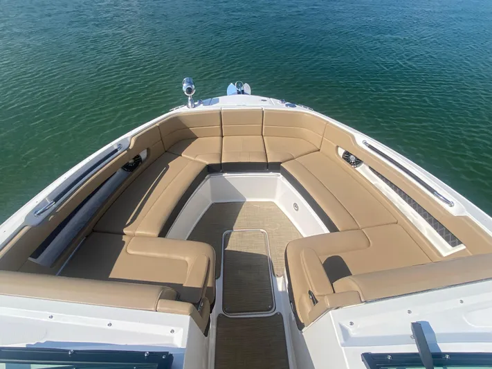 Casa - 2022 Sr 310 Slx @ Cancun Yacht Photos Pics 2022 Sea Ray SLX 310 boat with spacious tan seating on calm water.