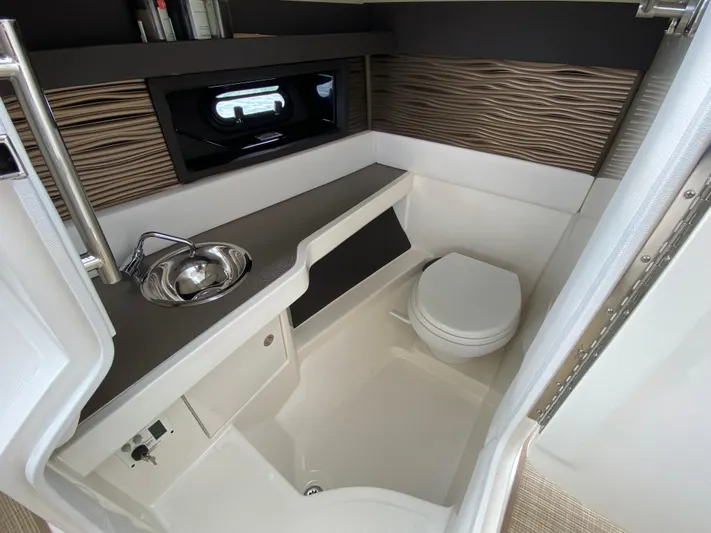 Casa - 2022 Sr 310 Slx @ Cancun Yacht Photos Pics 2022 Sea Ray SLX 310 boat bathroom with sink, toilet, and modern design.