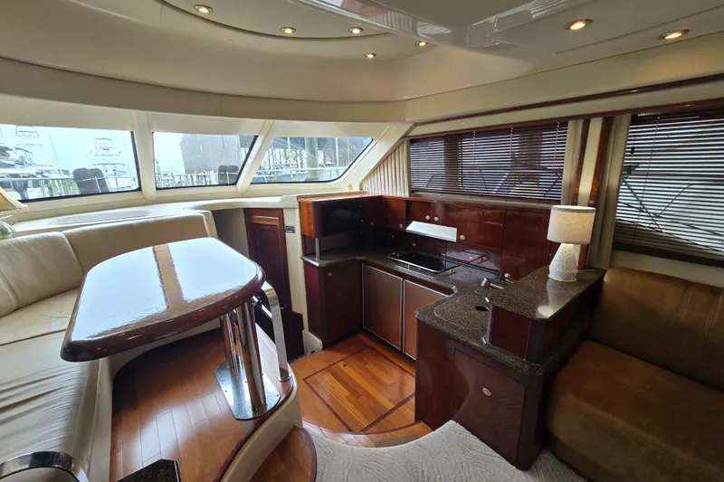 Verdee Yacht Photos Pics Luxurious interior of 2007 Sea Ray 52 Sedan Bridge yacht with modern kitchen and seating area.