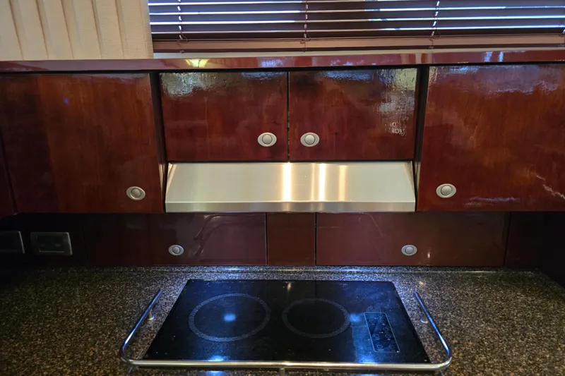 Verdee Yacht Photos Pics Luxurious kitchen area in a 2007 Sea Ray 52 Sedan Bridge yacht with sleek cabinetry.