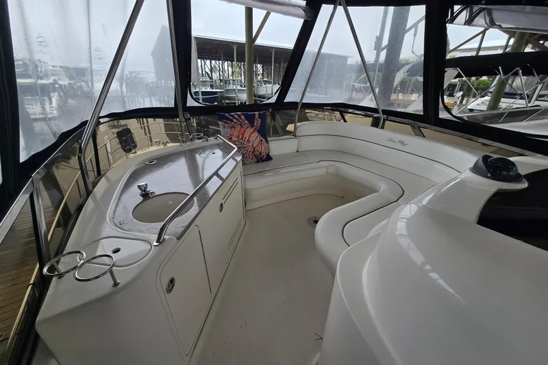 Verdee Yacht Photos Pics 2007 Sea Ray 52 Sedan Bridge interior with seating and sink, featuring panoramic windows.