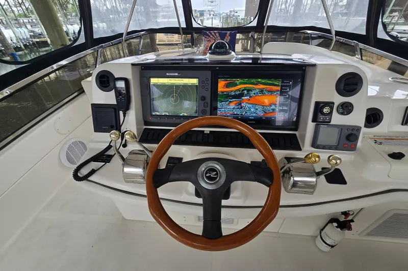 Verdee Yacht Photos Pics 2007 Sea Ray 52 Sedan Bridge helm with advanced navigation systems and wooden steering wheel.