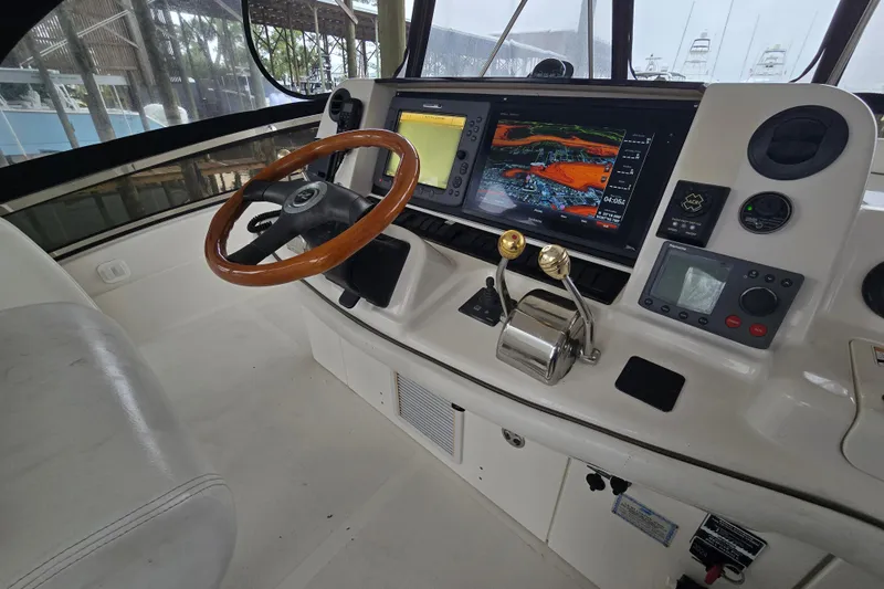 Verdee Yacht Photos Pics 2007 Sea Ray 52 Sedan Bridge helm with navigation screens and wooden steering wheel.