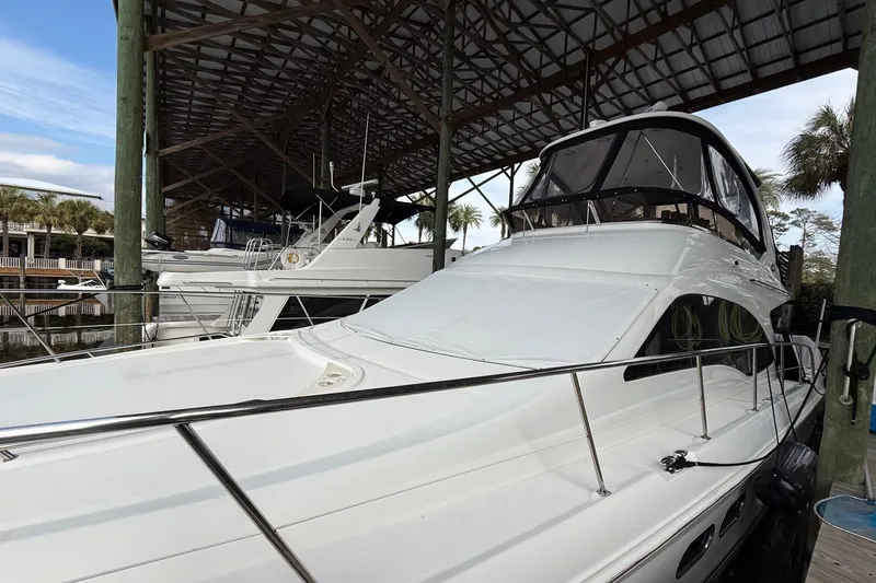 Verdee Yacht Photos Pics 2007 Sea Ray 52 Sedan Bridge yacht docked under a covered marina.