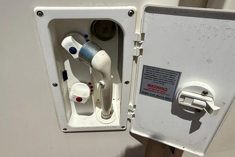 Verdee Yacht Photos Pics 2007 Sea Ray 52 Sedan Bridge water outlet with warning label and control handle.