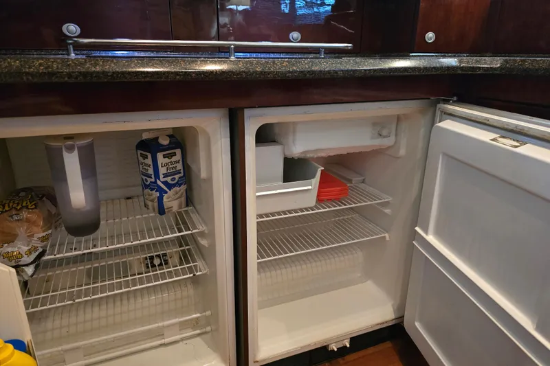 Verdee Yacht Photos Pics Refrigerator interior on 2007 Sea Ray 52 Sedan Bridge yacht, featuring lactose-free milk and bread.