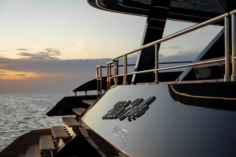 Petite Belle Yacht Photos Pics Sunset view of 2025 Sunreef 100 Power yacht, featuring sleek design and elegant railings.