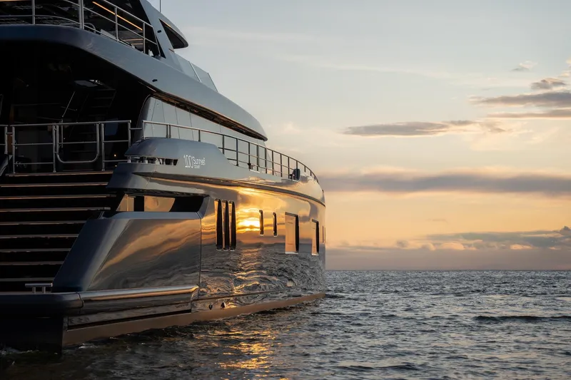 Petite Belle Yacht Photos Pics Luxurious 2025 Sunreef 100 Power yacht at sunset on the ocean.