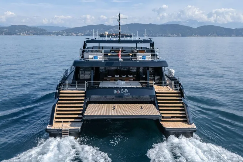 Petite Belle Yacht Photos Pics Luxurious 2025 Sunreef 100 Power yacht cruising on calm waters, showcasing elegant design.